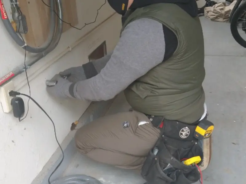 Electrician performing outlet wiring in a Lambertville garage